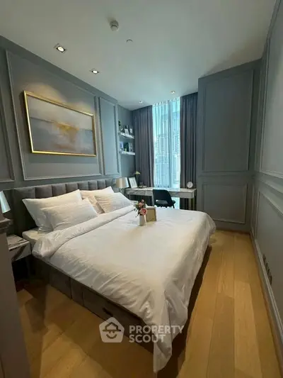 Luxurious bedroom with elegant decor and large window offering city views.