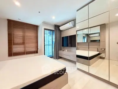 Modern bedroom with mirrored wardrobe and sleek design