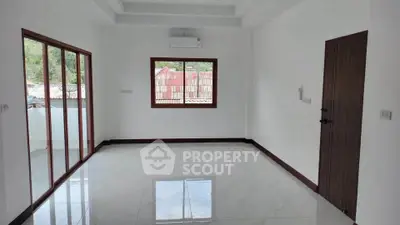 Spacious unfurnished living room with large windows and glossy tiled floor
