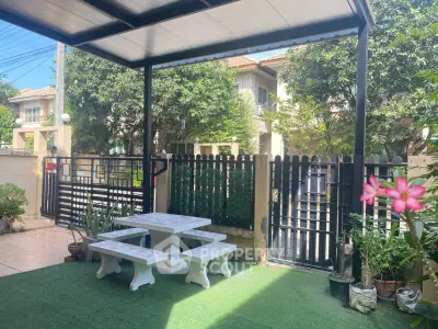 Charming garden patio with seating area and lush greenery