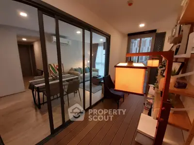 Modern living room with glass sliding doors and stylish decor in a cozy apartment.