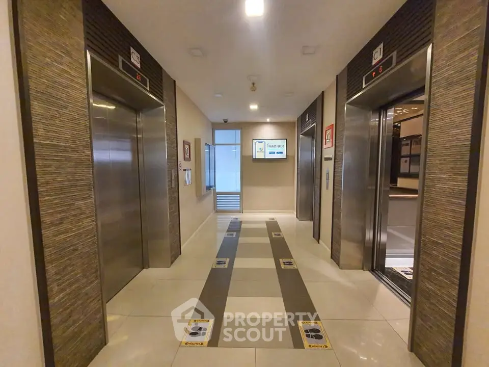 Modern elevator lobby with sleek design and spacious layout in a contemporary building.