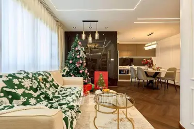 Luxurious living room with festive Christmas decor and elegant dining area