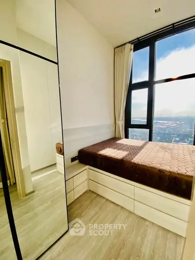 Modern bedroom with floor-to-ceiling windows and stunning city view