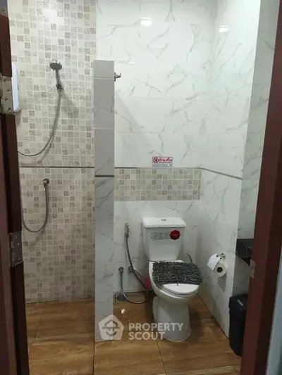 Modern bathroom with marble tiles and shower area