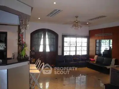 Spacious living room with modern decor and large windows for natural light.