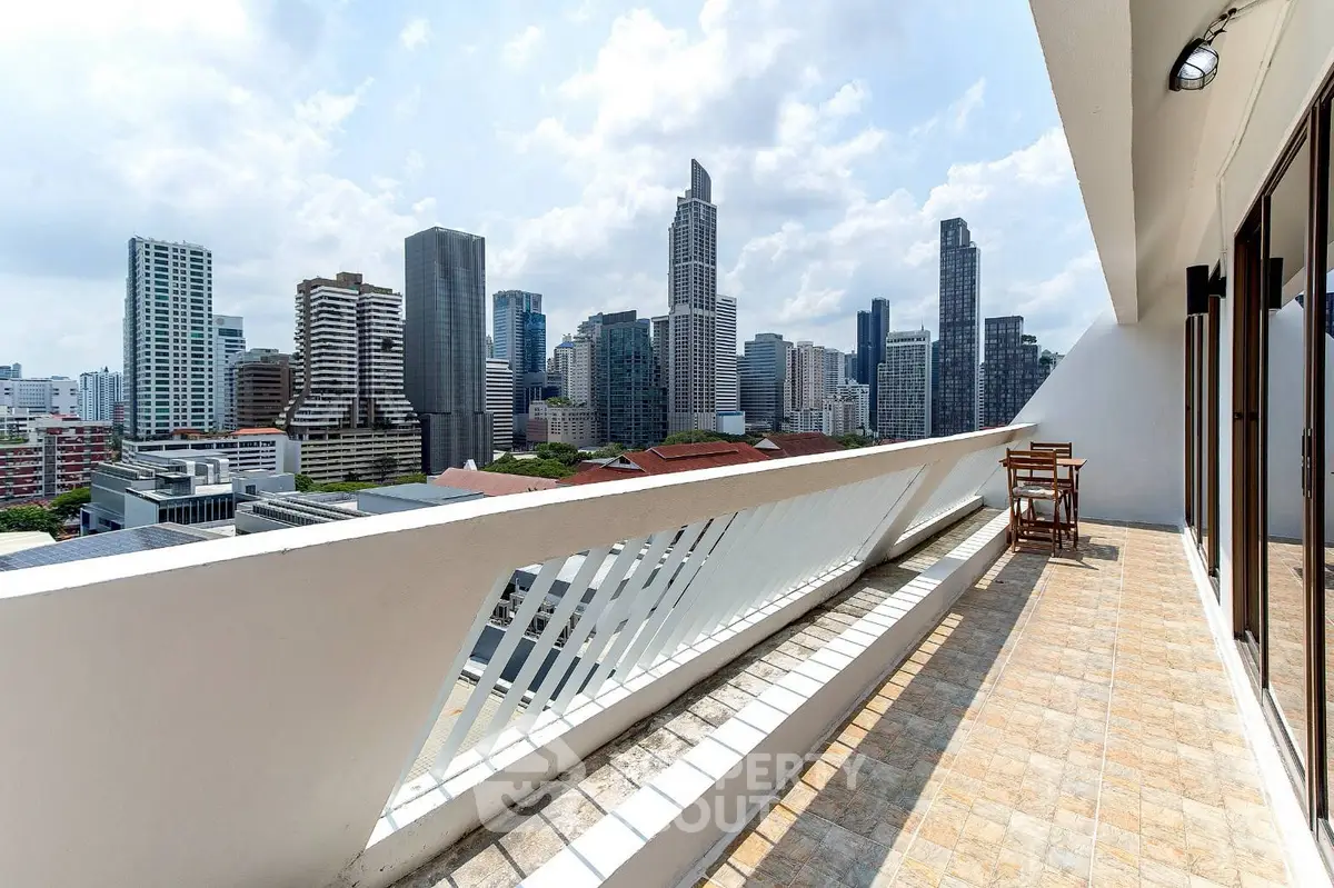 Stunning cityscape view from spacious balcony in modern high-rise apartment.