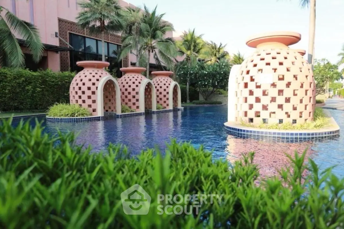 Luxurious poolside view with unique architectural features and lush greenery