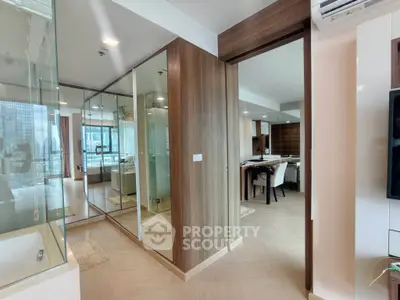 Modern apartment interior with open layout and city view, featuring stylish wood accents and ample natural light.