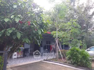Charming single-story home with lush greenery and spacious driveway, perfect for nature lovers.