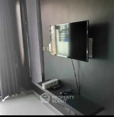 Modern living room with wall-mounted TV and sleek decor