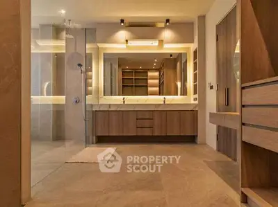 Luxurious modern bathroom with elegant wooden cabinetry and spacious shower area.