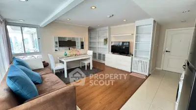 Spacious living room with modern decor and city view, featuring a cozy sofa and dining area.
