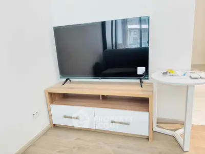 Modern living room with sleek TV stand and flat-screen TV, perfect for entertainment.