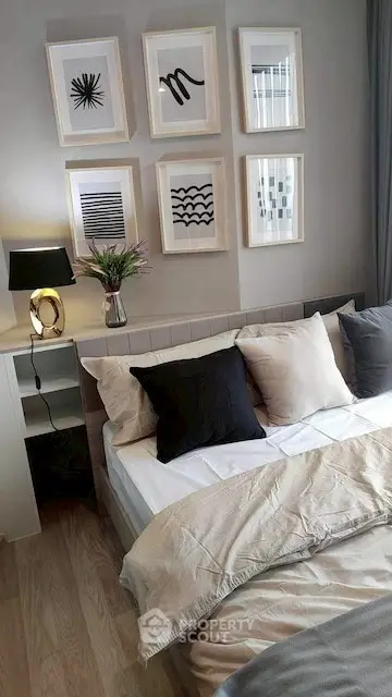 Cozy bedroom with stylish decor and framed art on the wall