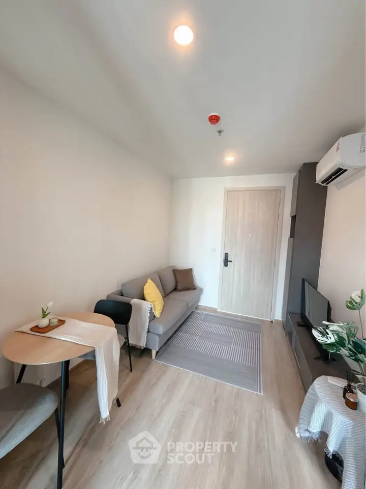 Modern living room with cozy sofa and stylish decor in a contemporary apartment.