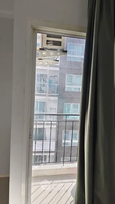 Modern apartment balcony with city view and sliding door access