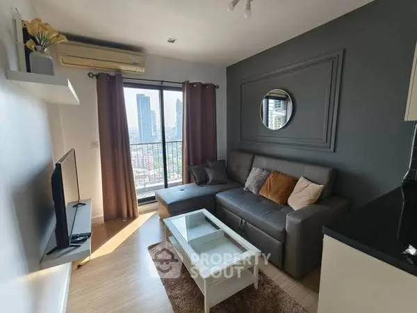 Modern living room with city view, stylish decor, and cozy seating area.