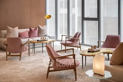 Elegant modern living room with stylish furniture and large windows.