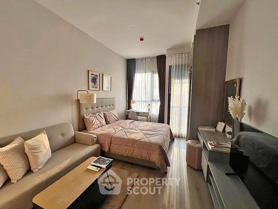 Modern bedroom with cozy sofa and natural light, perfect for relaxation and comfort.