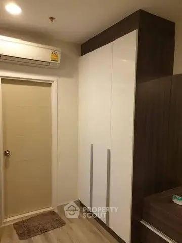 Modern bedroom with sleek wardrobe and air conditioning unit