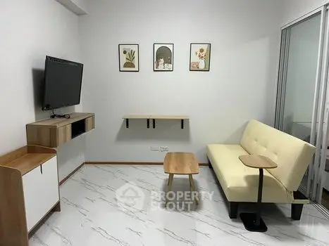Modern living room with minimalist decor and wall-mounted TV