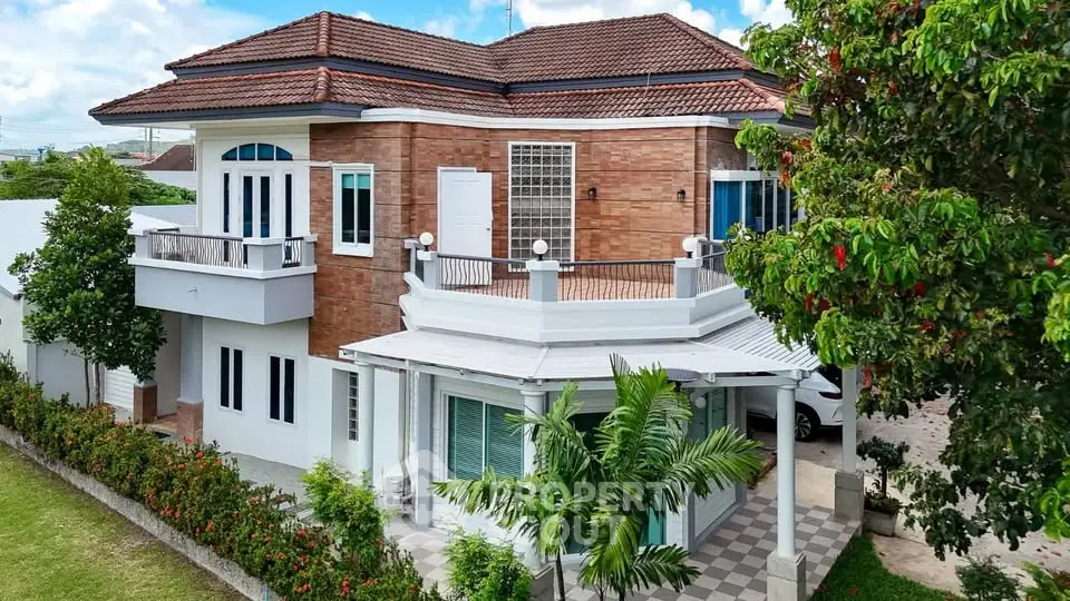 Stunning two-story house with brick facade and lush garden, perfect for family living.