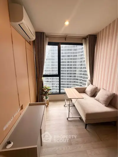 Modern living room with city view, featuring stylish sofa and air conditioning, perfect for urban living.
