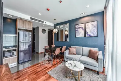 Modern living room with stylish decor, open kitchen, and cozy seating area in a contemporary apartment.