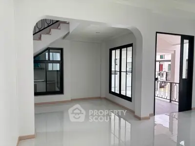 Spacious modern interior with glossy floors and large windows, perfect for natural light.