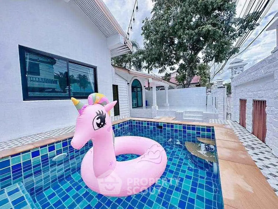 Charming pool area with unicorn float, perfect for relaxation and entertainment in a modern home.
