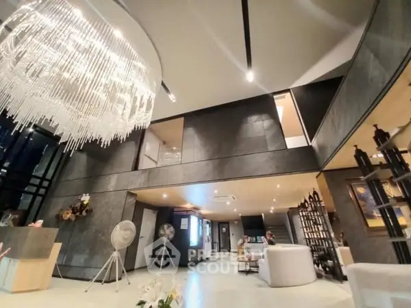 Luxurious modern living room with high ceilings and elegant chandelier