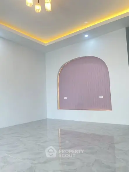 Modern minimalist interior with elegant lighting and unique wall feature.