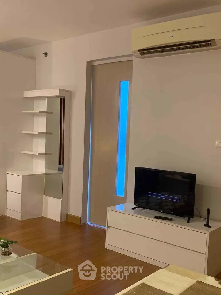 Modern living room with sleek furniture and air conditioning unit, perfect for comfortable living.