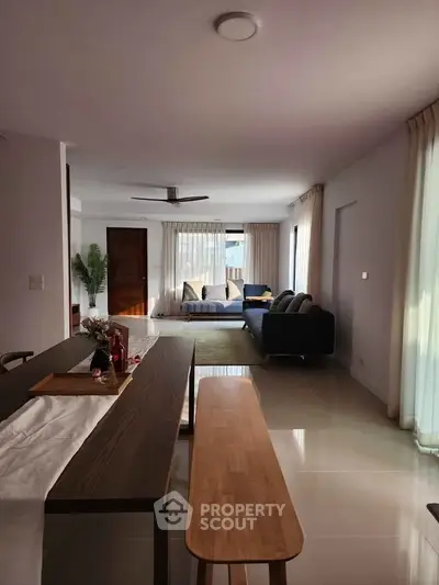 Spacious modern living room with elegant decor and ample natural light