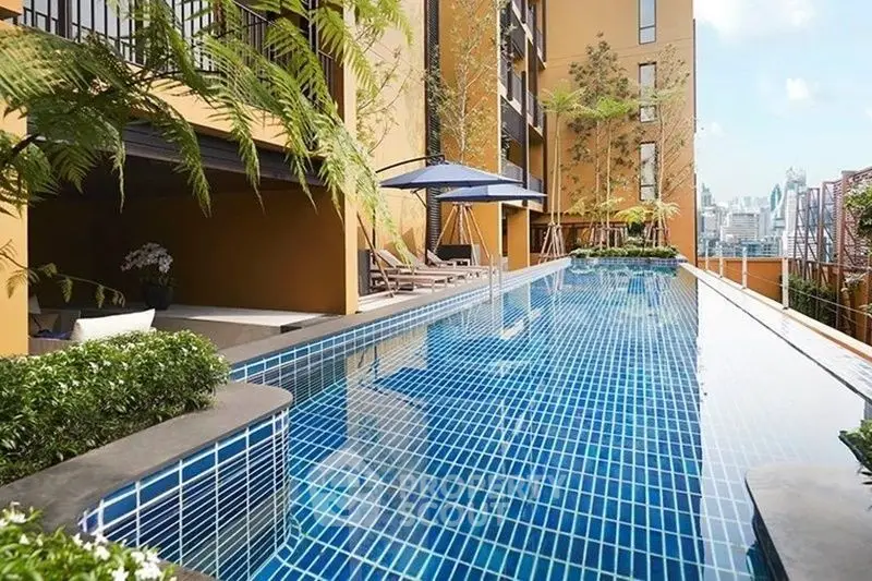 Luxurious rooftop pool with city skyline view and modern design.