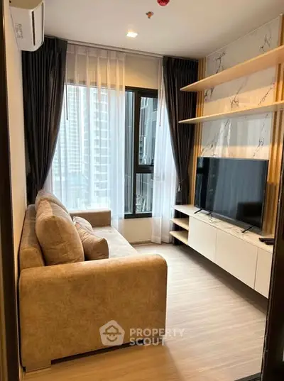 Modern living room with large window and stylish furniture in high-rise apartment.