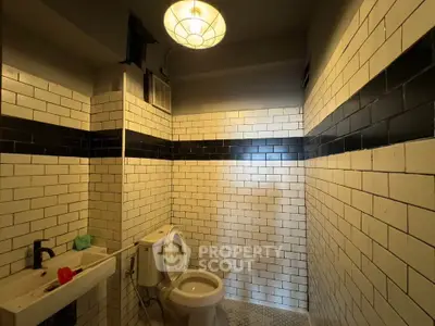 Chic industrial-style bathroom with subway tiles and modern fixtures.