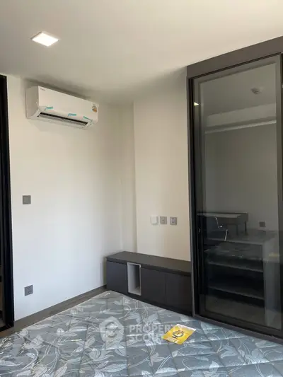 Modern bedroom with air conditioning and glass sliding door