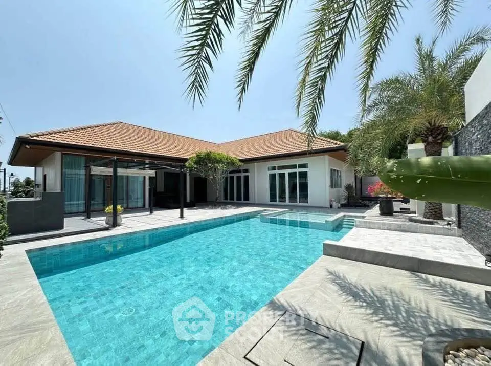 Luxurious villa with private pool and palm trees, perfect for tropical living.