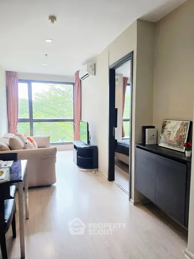 Bright and airy living room with large windows and modern furnishings in a stylish apartment.