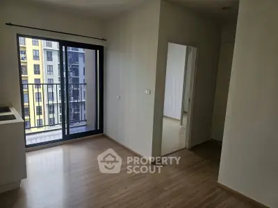 Modern apartment interior with wooden flooring and balcony view
