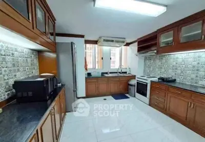 Spacious kitchen with modern appliances and elegant cabinetry, perfect for culinary enthusiasts.