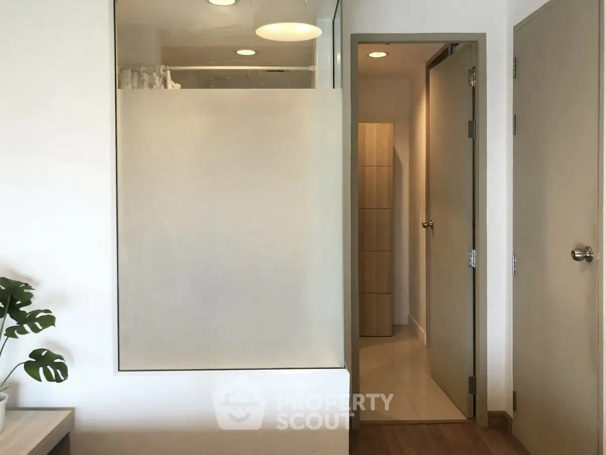 Modern bathroom with frosted glass and wooden accents