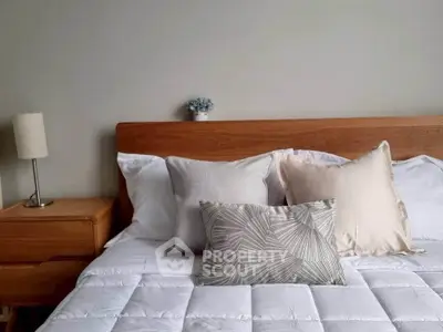 Cozy bedroom with wooden headboard and stylish pillows
