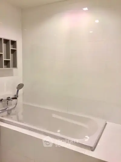 Modern bathroom with sleek white bathtub and minimalist design