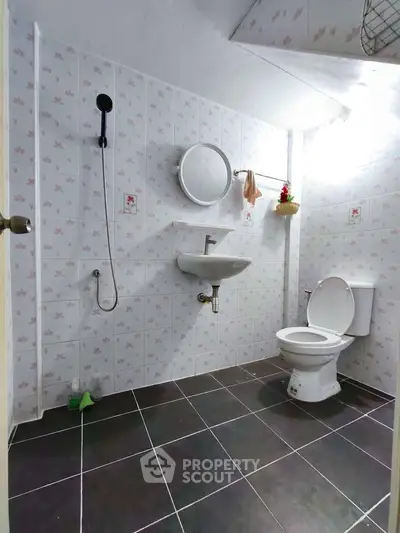 Spacious bathroom with modern fixtures and stylish tile design.