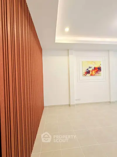 Modern interior with elegant wood paneling and stylish artwork, perfect for contemporary living spaces.