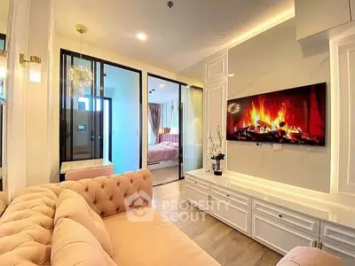 Luxurious living room with elegant decor and modern fireplace, leading to a cozy bedroom.