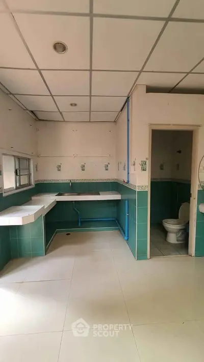 Spacious bathroom with green tile accents and modern fixtures